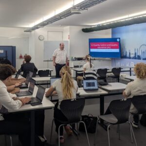 Westbourne College business management class with students working on laptops during a lecture