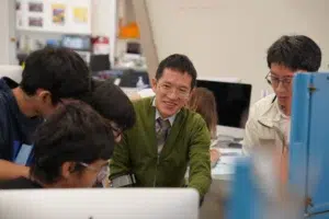 Year 10 Students And Teacher Dr Poker Collaborating In A Classroom At Westbourne College Sydney